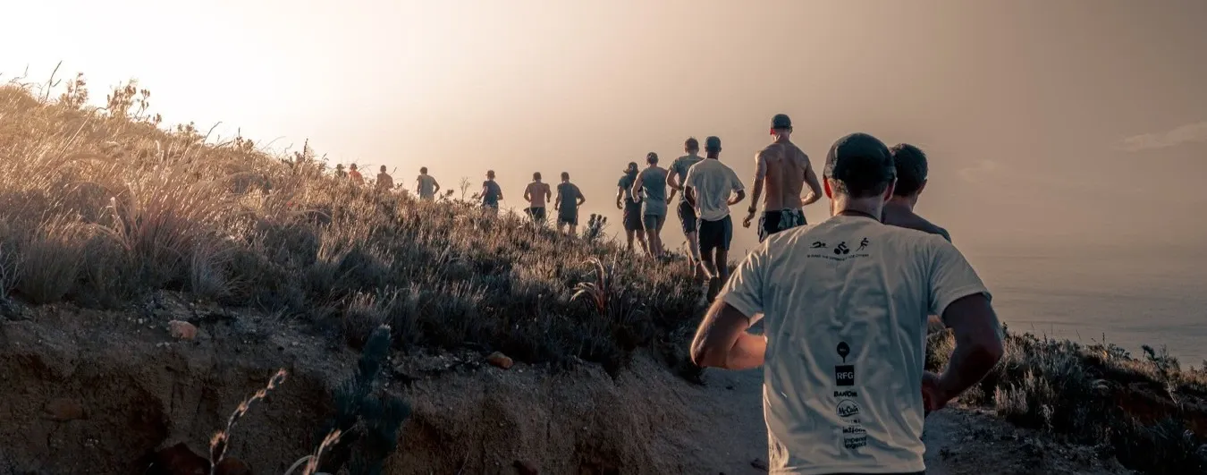 Leopards runners sharing coffee and pastries around a long table after a run